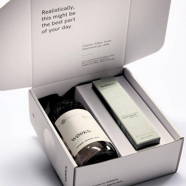WØRKS Cumquat Gift Box open, showing Botanical Wash and Botanical Hand Cream inside FSC-certified packaging