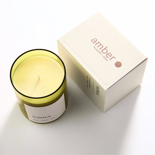 WØRKS Amber Aromatic Candle in smoked glass jar shown with its packaging box