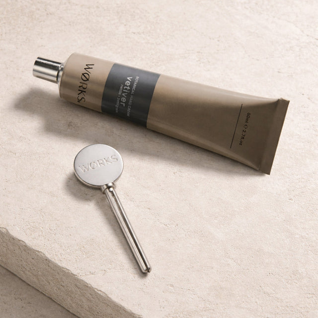 WØRKS Tube Key in use — zinc alloy accessory for hand cream and body balm aluminium tubes, Melbourne
