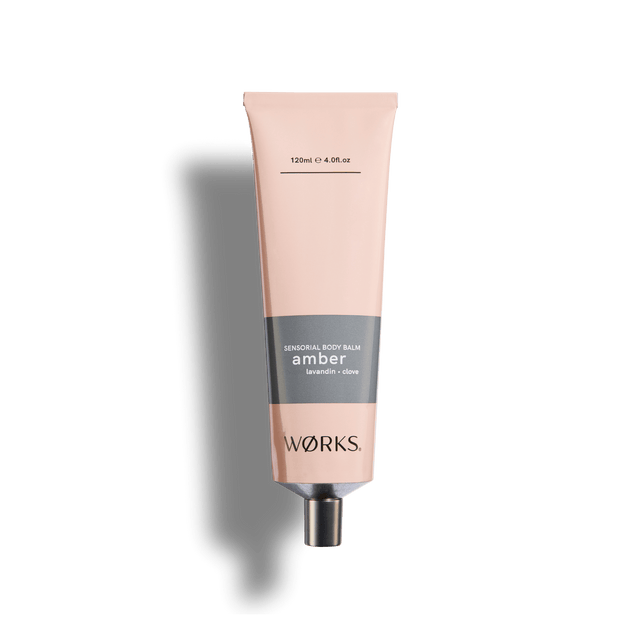 Amber 120ml body balm tube in WØRKS signature packaging, photographed on a clean white background