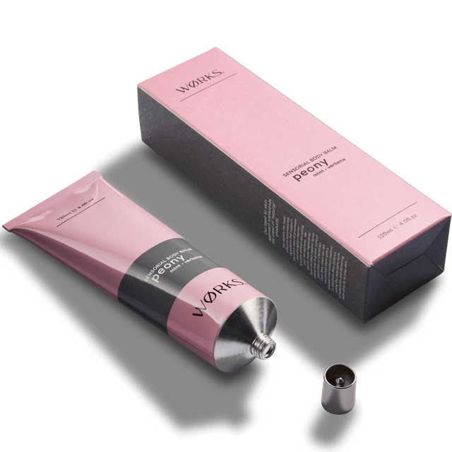 Peony 120ml body balm tube with minimal design and luxurious texture, captured in soft natural light