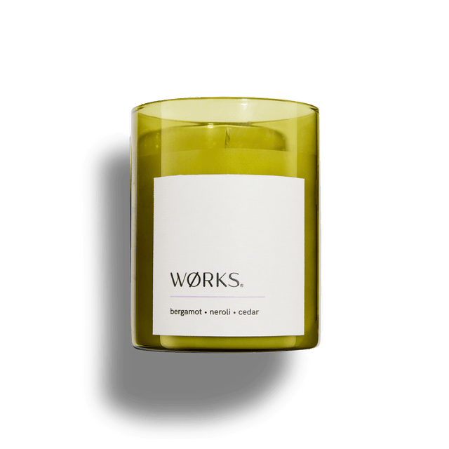Unboxed WØRKS Bergamot candle in smoked glass jar, photographed with soft shadows