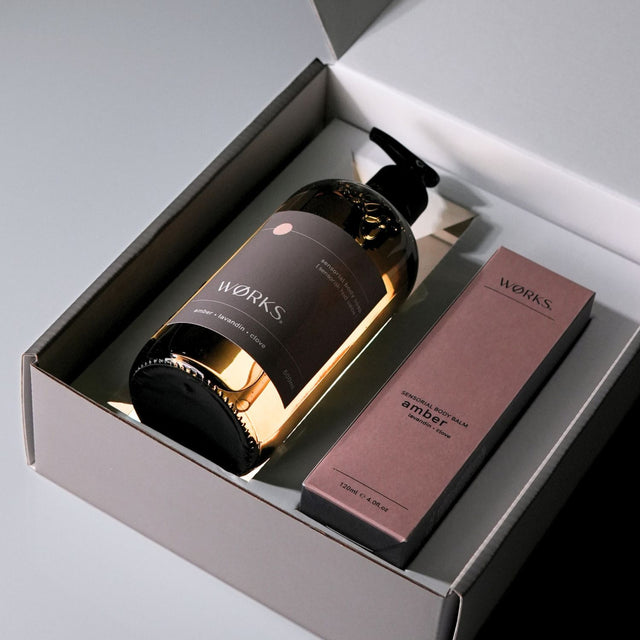 Open gift box with Amber products emerging from inside, styled for visual impact