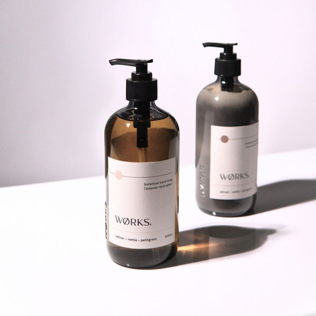Vetiver Hand Care Duo — 500ml glass bottles styled on soft, natural backdrop