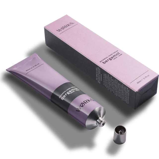 Bergamot 80ml hand cream tube with minimal design and luxurious texture, captured in soft natural light