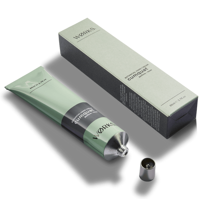 Cumquat 80ml hand cream tube with minimal design and luxurious texture, captured in soft natural light