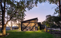 The glass-walled Anvers restaurant at dusk among gum trees on Razorback Road, Kangarilla