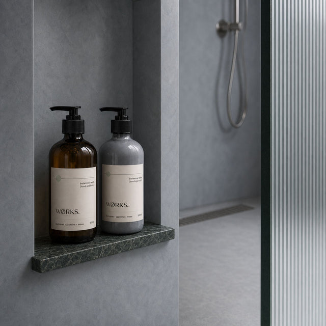WØRKS Wall Bracket in matte black styled in situ, holding a WØRKS 500ml glass bottle