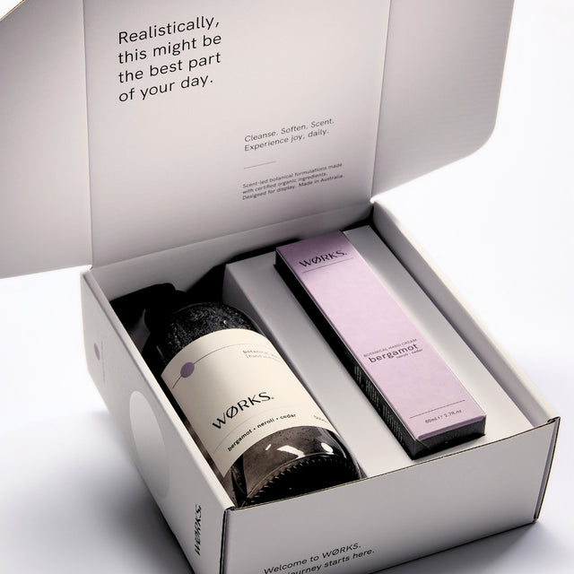 WØRKS Bergamot Gift Box open, showing Botanical Wash and Botanical Hand Cream inside FSC-certified packaging