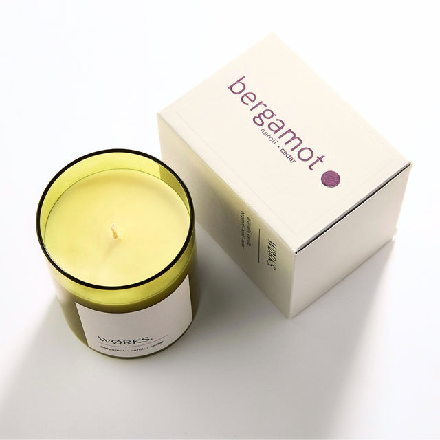 WØRKS Bergamot Aromatic Candle in smoked glass jar shown with its packaging box