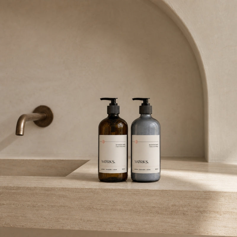 WØRKS Amber Botanical Duo styled in situ — 500ml Botanical Wash and Botanical Balm in smoky glass