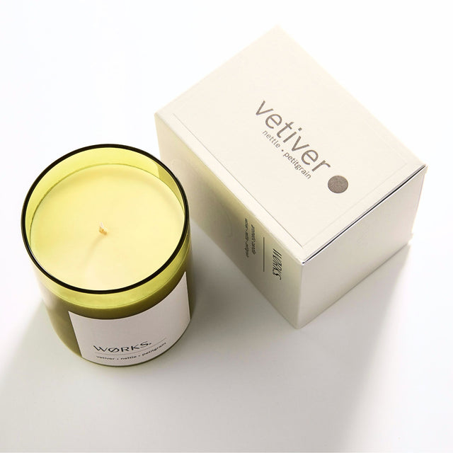 WØRKS Vetiver Aromatic Candle in smoked glass jar shown with its packaging box