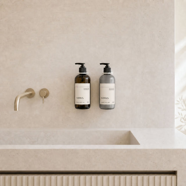 WØRKS Wall Bracket in white styled in situ, holding a WØRKS 500ml glass bottle